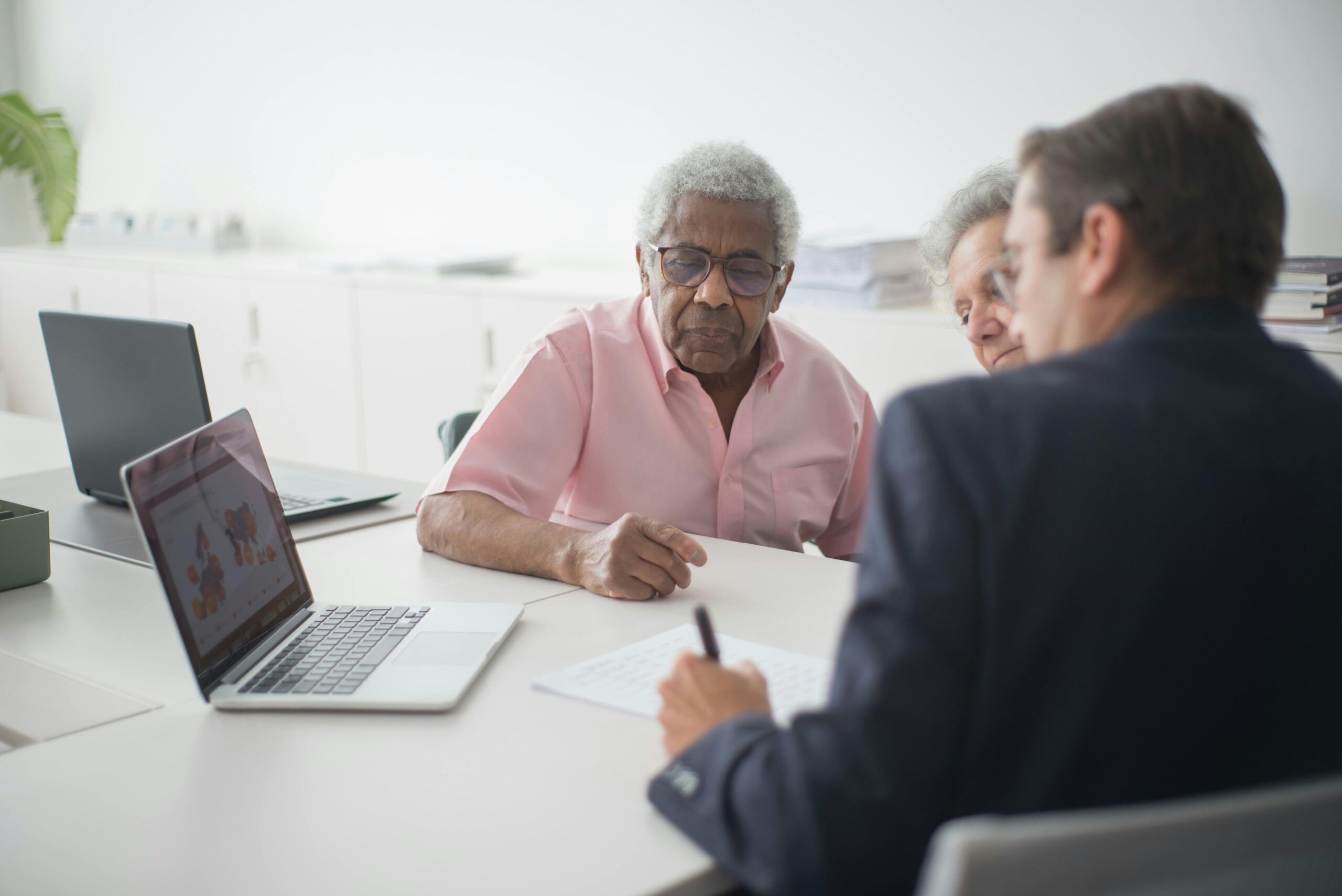 Conversation about Term Life Insurance between a man in a suit and two elderly people